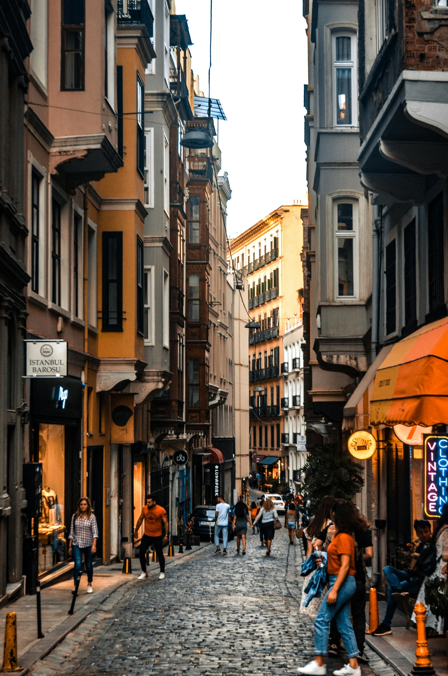 a group of people walking down a cobblestone street, by Cafer Bater, pexels contest winner, renaissance, fallout style istanbul, storefronts, summer evening, today\'s featured photograph 4k