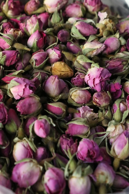 a bowl filled with lots of pink roses, inspired by Jacopo Bassano, reddit, dried herbs, closeup - view, market, purple