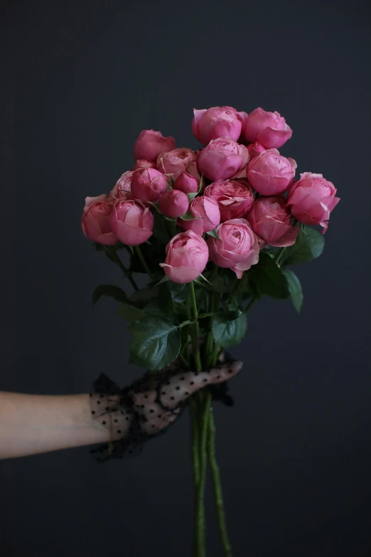 a person holding a bunch of pink roses, inspired by Pierre-Joseph Redouté, unsplash, with black, peony, floral lacework, tall