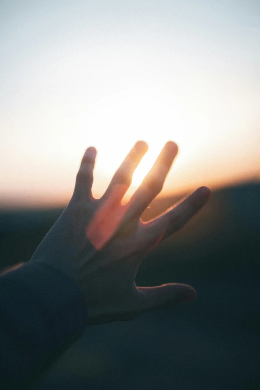 a person holding their hand up to the sun, pexels, paul barson, last light, soft texture, instagram post