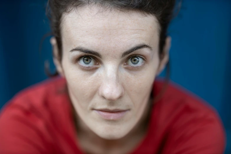 a close up of a person wearing a red shirt, a portrait, by Helen Biggar, staring directly into camera, sanja stikovic, spotlight in middle of face, lightweight