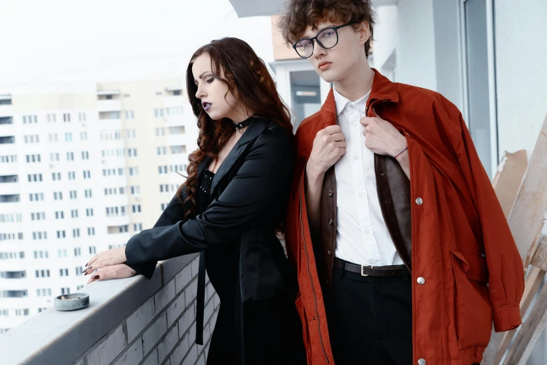 a man and a woman standing on a balcony, an album cover, trending on pexels, bauhaus, brunette boy and redhead boy, trenchcoat, nerdy appearance, anna nikonova aka newmilky
