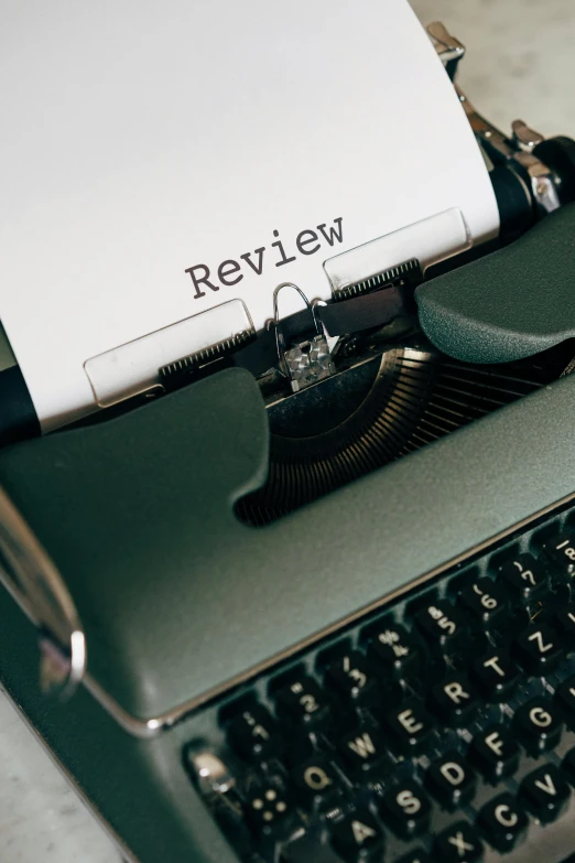 a typewriter with a paper on top of it, by Robbie Trevino, unsplash contest winner, paperback cover, rating: general, toy photo, do