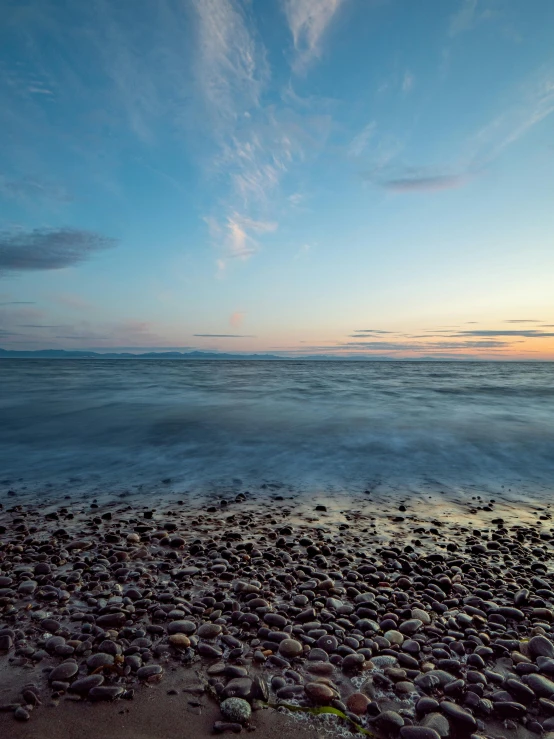a large body of water sitting on top of a sandy beach, by Jason Felix, unsplash, at twilight, 2 5 6 x 2 5 6 pixels, reykjavik, ripples