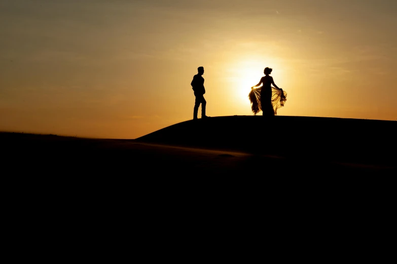 a couple of people standing on top of a hill, by Matthias Weischer, pexels contest winner, romanticism, tuareg, afternoon sun, wedding, arabian night