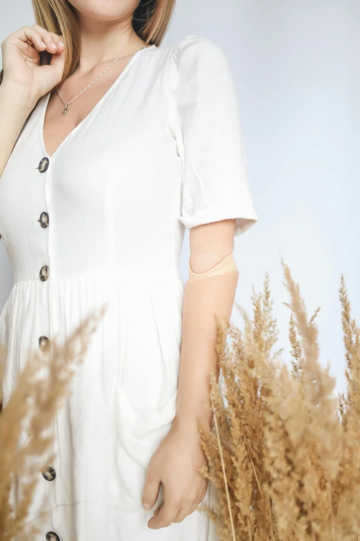 a woman in a white dress posing for a picture, an album cover, inspired by Cui Bai, trending on pexels, buttons, detailed product image, white sleeves, cottagecore!! fitness body