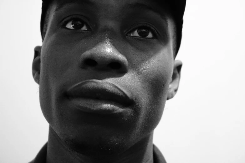 a close up of a person wearing a hat, an album cover, black main color, clean shaven, ansel ], taken in the late 2010s