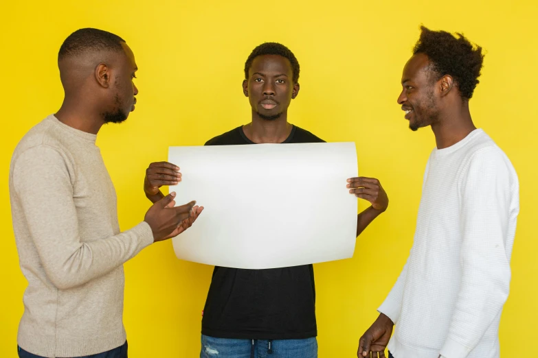 three men standing next to each other holding a sign, pexels contest winner, visual art, on a yellow paper, ( ( dark skin ) ), dark people discussing, profile image