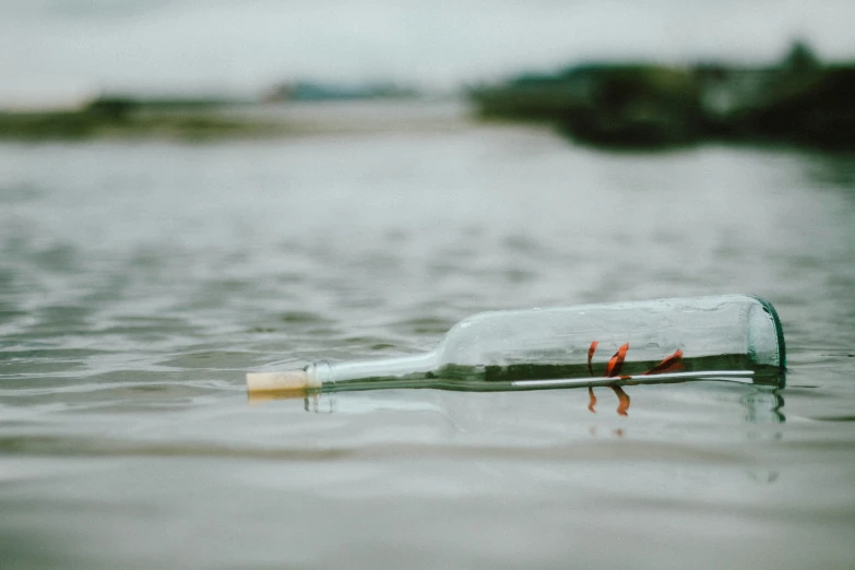 a message in a bottle floating in the water, pexels contest winner, environmental art, small boat, scratched vial, lostfish, promo image