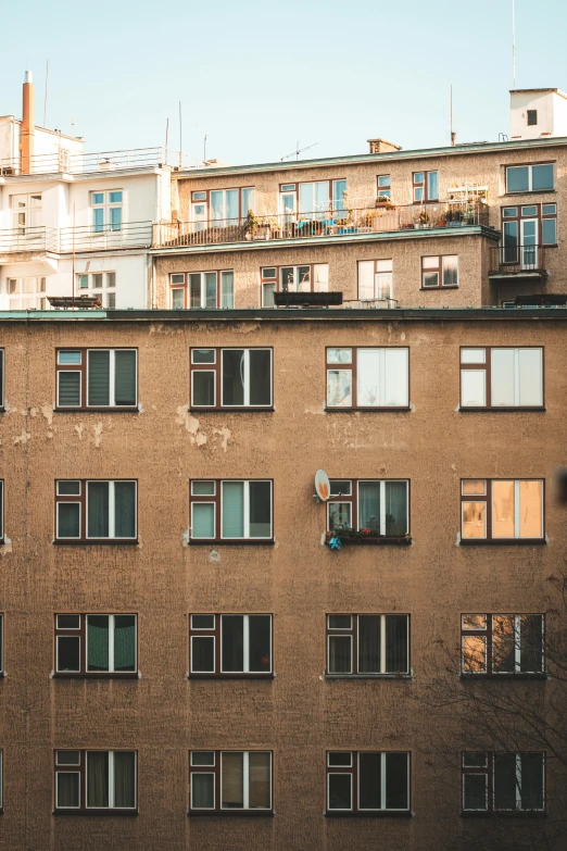 a tall building with lots of windows and balconies, a photo, inspired by Elsa Bleda, pexels contest winner, modernism, ground level view of soviet town, light - brown wall, 15081959 21121991 01012000 4k, berghain