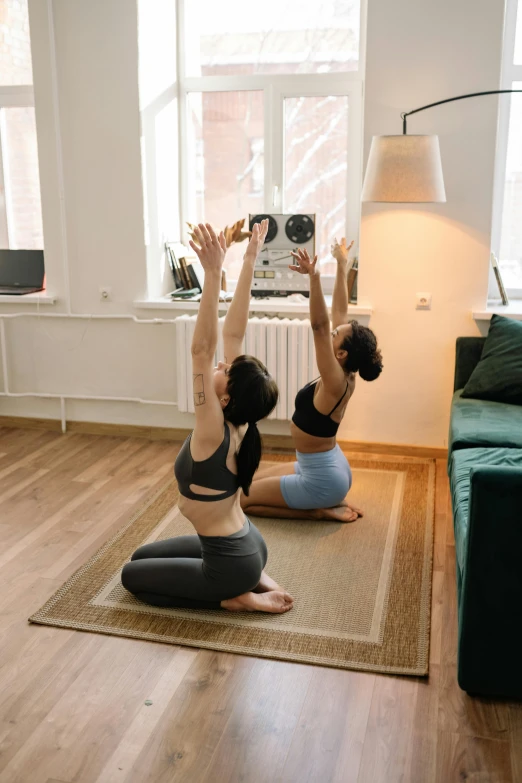 two women doing yoga in a living room, by Adam Marczyński, pexels contest winner, renaissance, back turned, low quality photo, islamic, slim