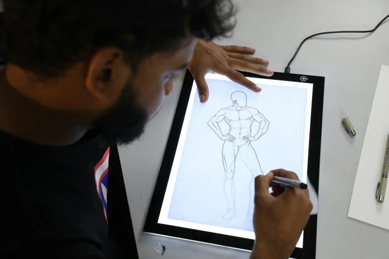 a man is drawing on a computer screen, cyborg hindu godbody, glowforge template, ipad pro, reddit post