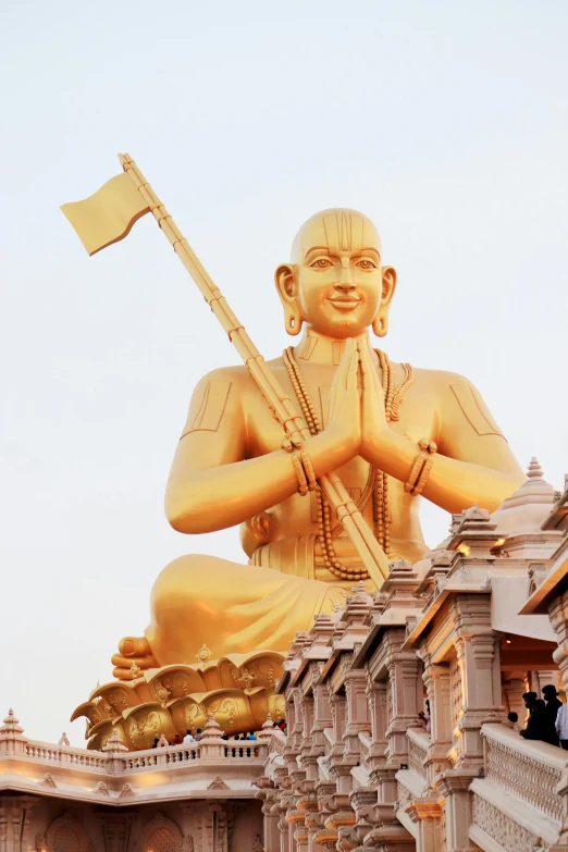 a large statue of a man sitting on top of a building, inspired by Ram Chandra Shukla, samikshavad, sam hyde in gold suit, 2 5 6 x 2 5 6 pixels, fisting monk, trending on