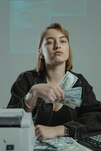 a woman sitting at a desk in front of a printer, a colorized photo, inspired by Elsa Bleda, pexels contest winner, hyperrealism, dollar bills, portrait sophie mudd, witch paying for her sins, female marty mcfly
