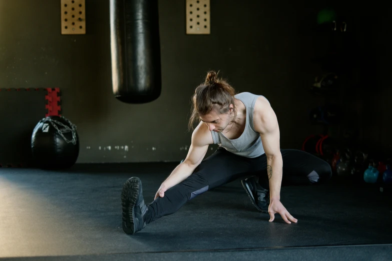 a woman doing push ups in a gym, by Emma Andijewska, pexels contest winner, hurufiyya, doing splits and stretching, profile image, thumbnail, cracks