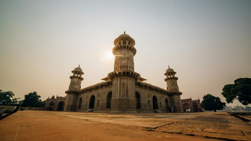 a large building sitting on top of a dirt field, unsplash contest winner, renaissance, islamic architecture, india, sunlight glistening, tomb