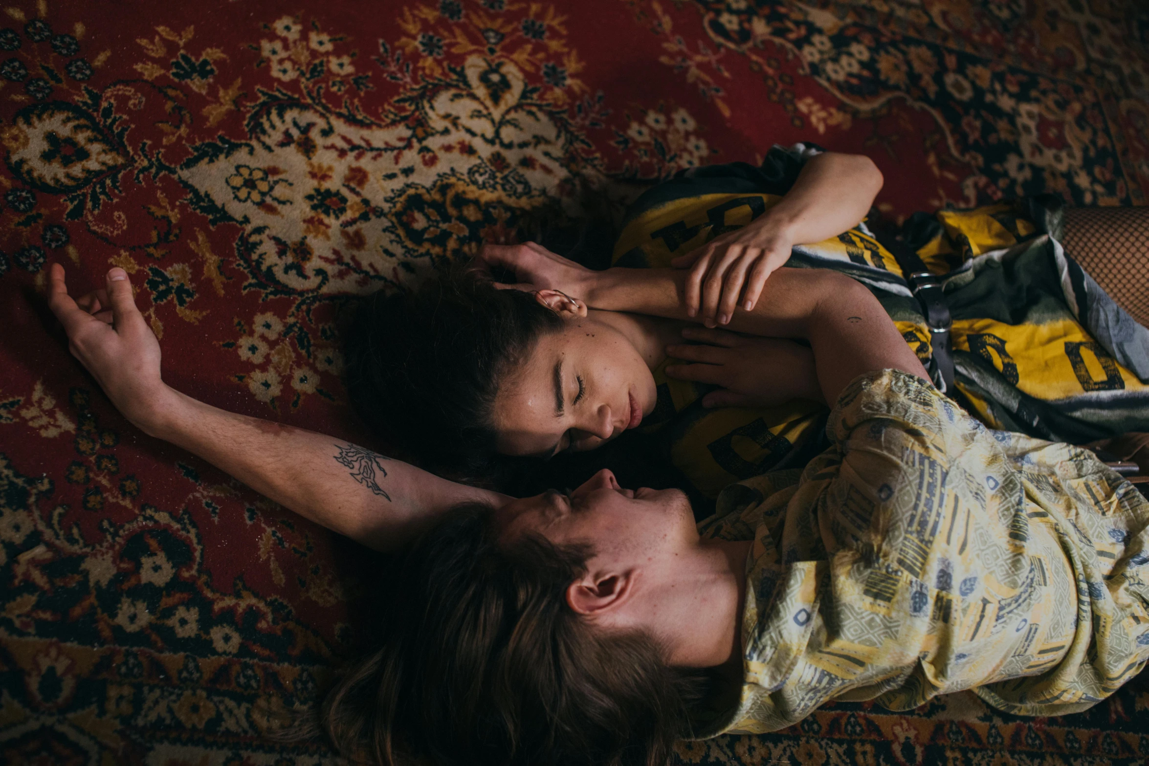 a man and a woman laying on a rug, by Elsa Bleda, trending on pexels, renaissance, lesbians, boy girl traditional romance, dreaming bodies, ignant