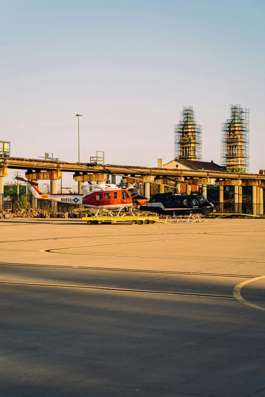 a red helicopter sitting on top of an airport tarmac, by Sven Erixson, pexels contest winner, chemical plant, minneapolis, panoramic shot, square