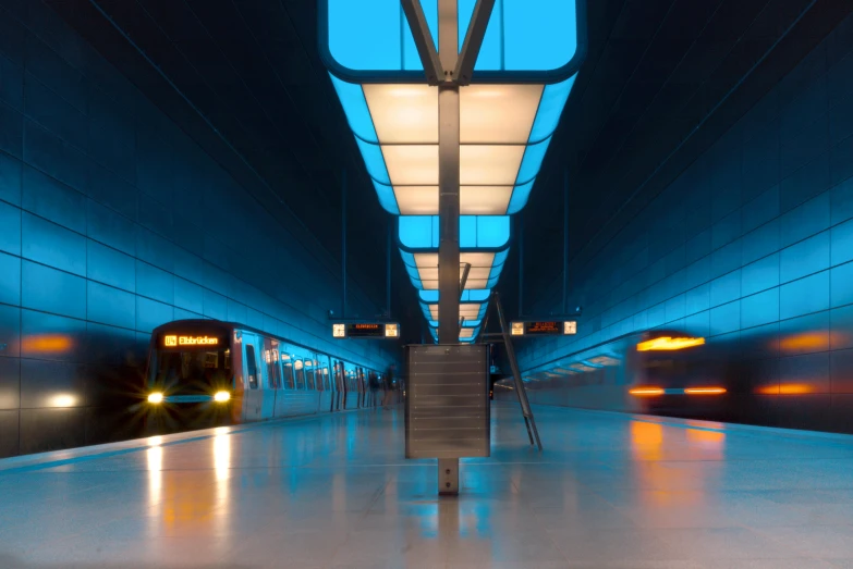 a train pulling into a train station at night, a picture, by Jens Søndergaard, unsplash contest winner, blue lamps on the ceiling, square, avatar image, but minimalist