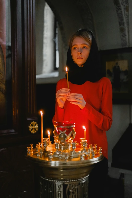 a woman lighting a candle in a church, inspired by Andrei Rublev, pexels, looking serious, teenage girl, still from a wes anderson film, reliquary