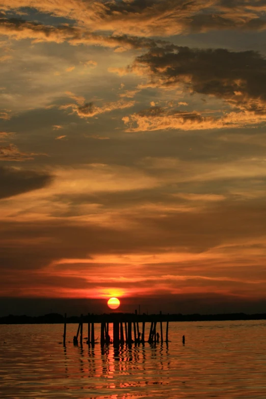 the sun is setting over a body of water, flickr, cambodia, trending photo, a wooden, ..'