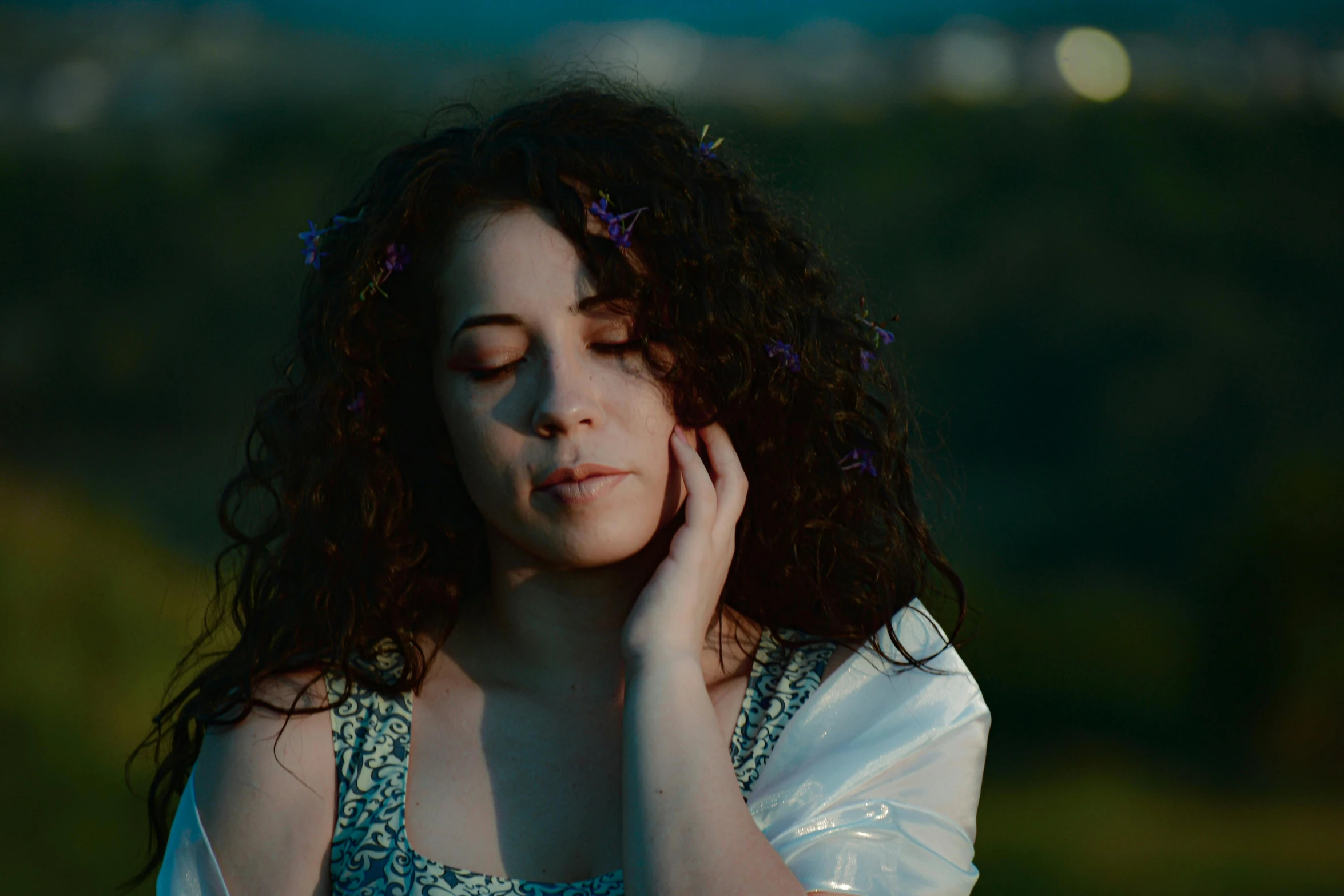 a woman with curly hair wearing a blue dress, pexels contest winner, at twilight, still from l'estate, thoughtful ), still from a music video