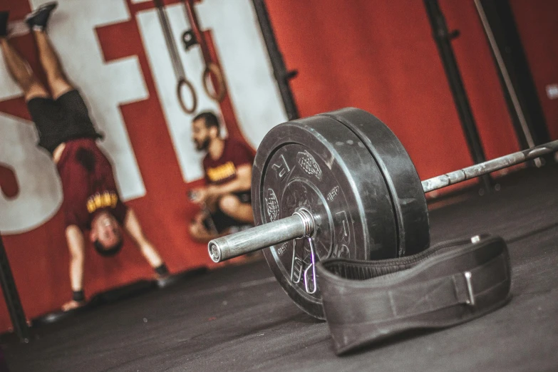 a close up of a barbell on a gym floor, by Adam Marczyński, pexels contest winner, train with maroon, avatar image, full faced, 🦩🪐🐞👩🏻🦳