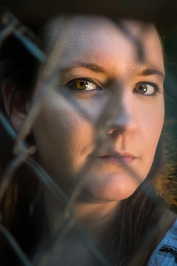 a close up of a person behind a fence, portrait of maci holloway, serious lighting, jennifer wuestling, profile image