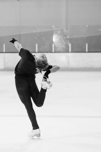 a woman skating on an ice rink in a black and white photo, by Anna Haifisch, arabesque, made of ice, dabbing, [ floating ]!!, kacper niepokolczycki