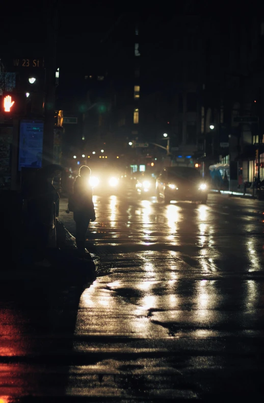 a city street filled with lots of traffic at night, an album cover, inspired by Elsa Bleda, tonalism, wet pavement, new york streets, clean streets, headlights turned on