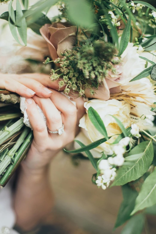 a close up of a person holding a bunch of flowers, delicate embellishments, romantic greenery, emerging hands, impression