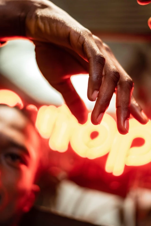 a close up of a person holding a stop sign, by Nick Fudge, happening, dramatic neon lighting, hiphop, eyes are glowing red lightbulbs, hands on counter