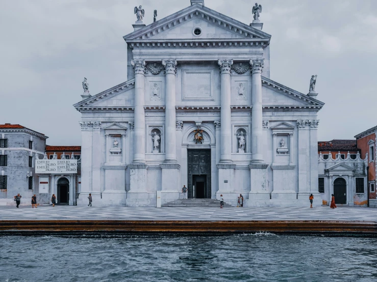 a large white building next to a body of water, a marble sculpture, by Canaletto, pexels contest winner, church, thumbnail, biennale, frontal picture