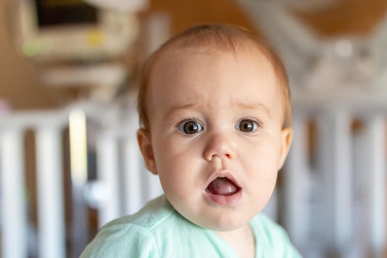 a close up of a baby in a crib, pexels contest winner, happening, shocked expression, front facing, portrait of small
