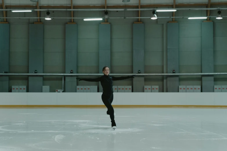 a man in a black suit skating on an ice rink, by Emma Andijewska, arabesque, **cinematic, a wide shot, square, netflix