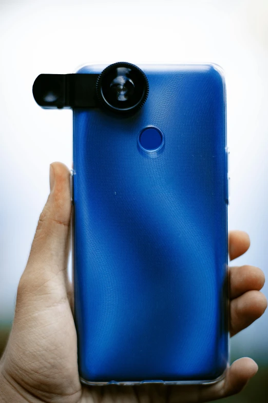 a close up of a person holding a cell phone, a picture, blue, long lens, cell cover style, 3 6 0 picture