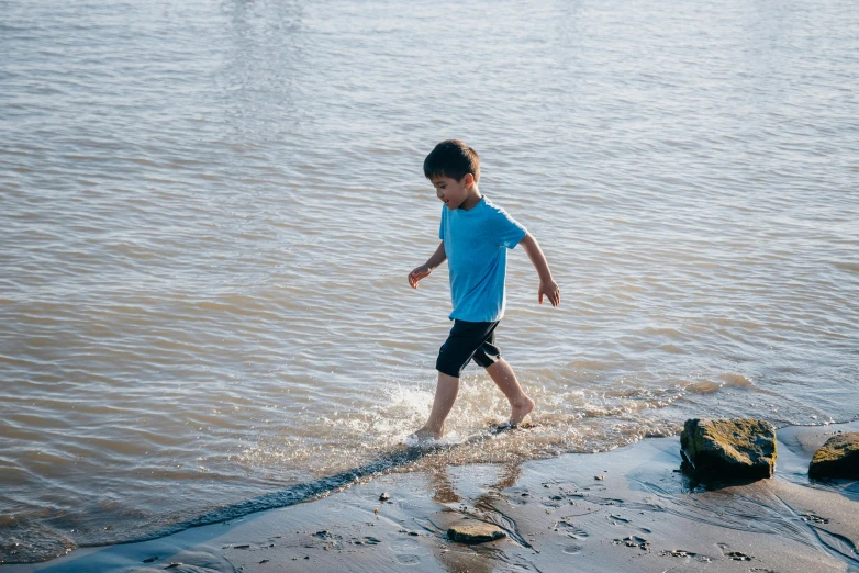 a little boy that is walking in the water, pexels contest winner, the thames is dry, at full stride, 5k, thumbnail