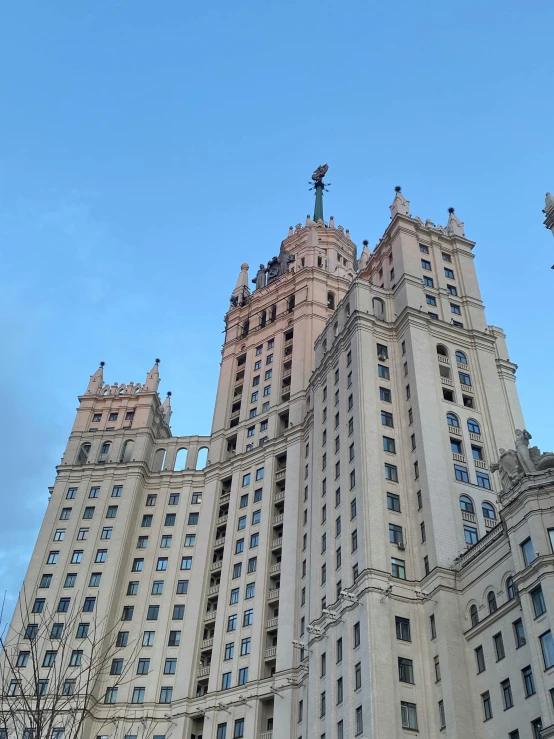 a tall building with a clock on top of it, socialist realism, three towers, photo taken in 2018, фото девушка курит, light above palace