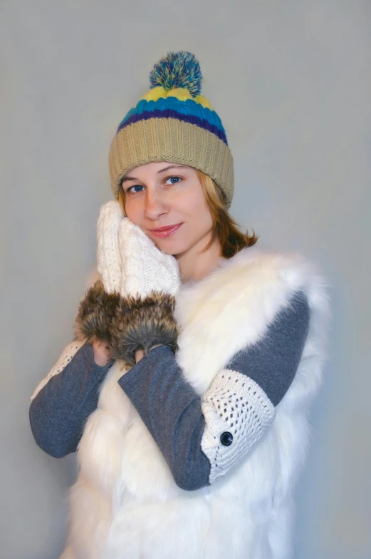 a woman wearing a fur vest and gloves, inspired by Louisa Matthíasdóttir, knitted hat, cold colours, cute and cuddly, photograph taken in 2 0 2 0