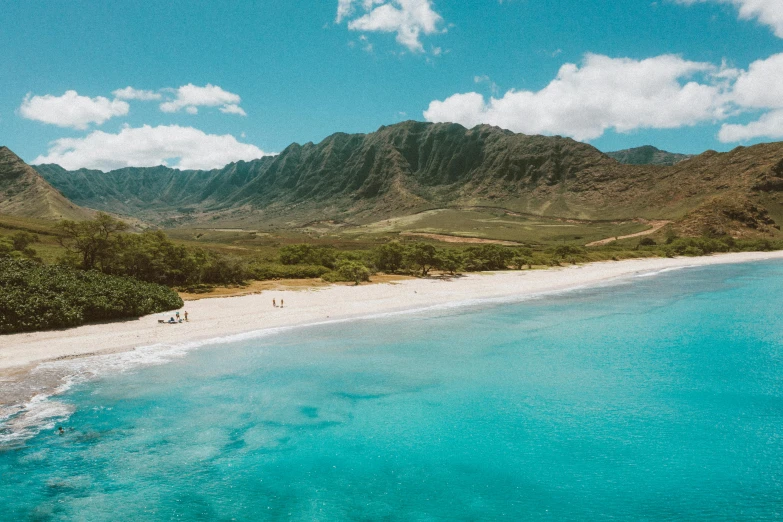 a view of a beach with mountains in the background, a photo, hawaii beach, flatlay, clear blue skies, instagram post