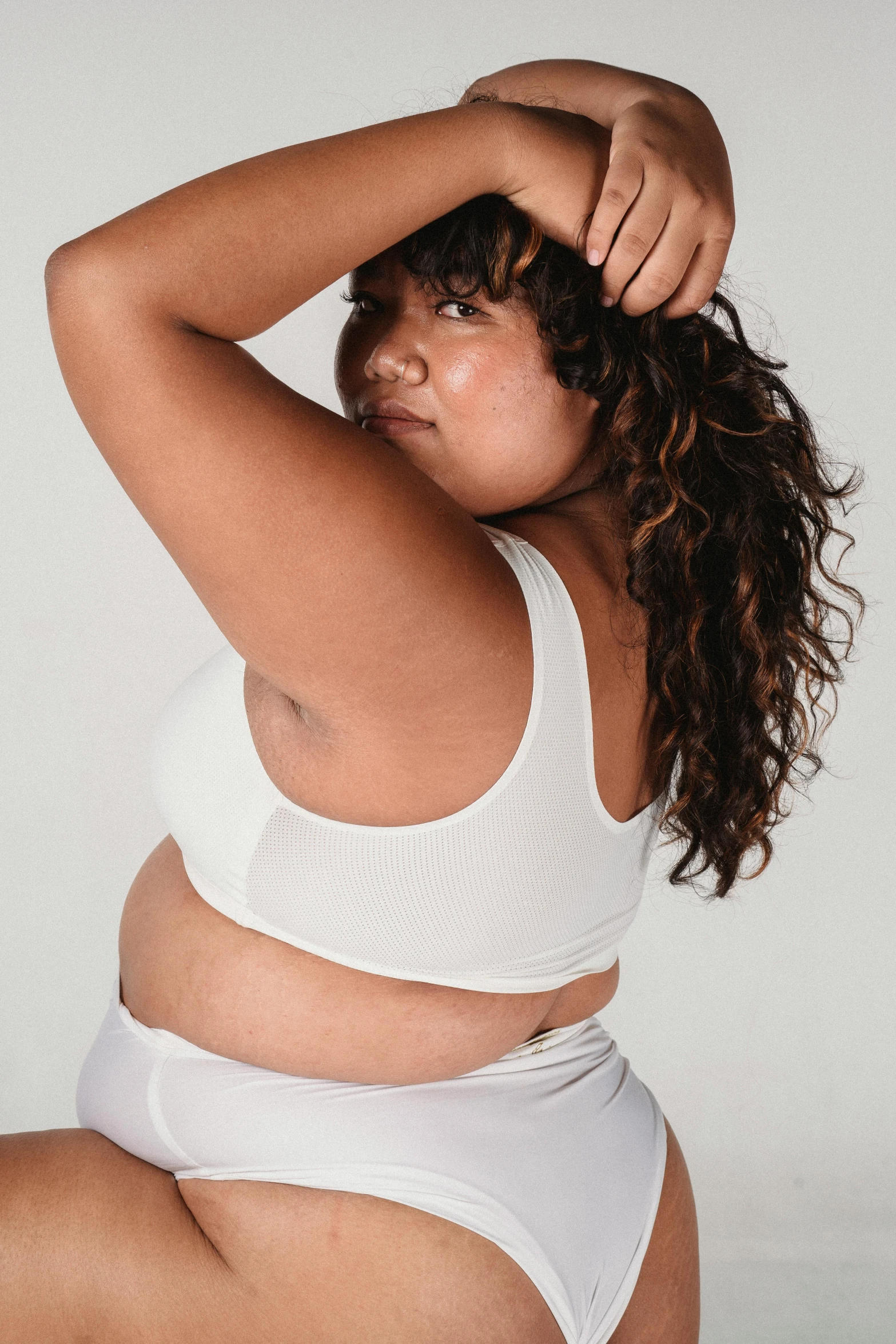 a woman in a white underwear posing for a picture, wearing a cropped tops, overweight, looking off into the distance, uncrop