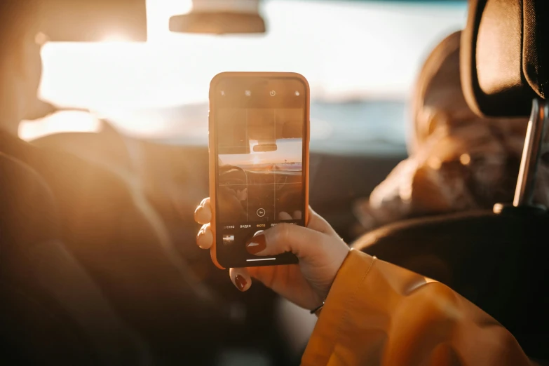 a person holding up a cell phone in a car, a picture, by Niko Henrichon, trending on pexels, happening, hasselblad photo, avatar image, vacation photo, instagram post 4k