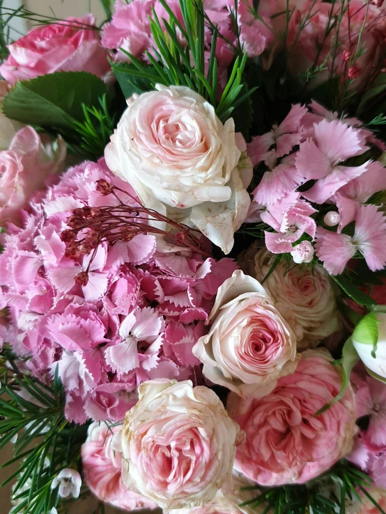 a bouquet of pink and white flowers on a table, up-close, breathtaking quality, intricate features, award - winning