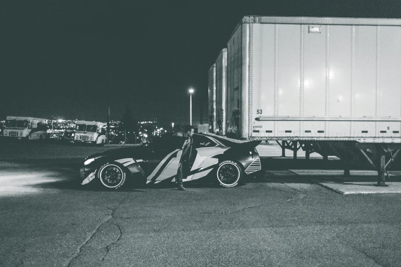 a black and white photo of a car in front of a truck, a black and white photo, unsplash, toyota supra, full body 8k, late night, asher duran