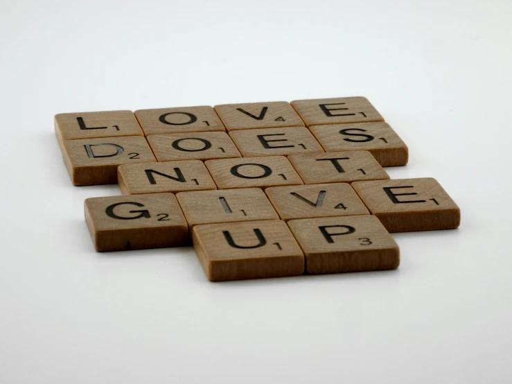 wooden scrabbles spelling love does not give up, tan, thumbnail, one, press