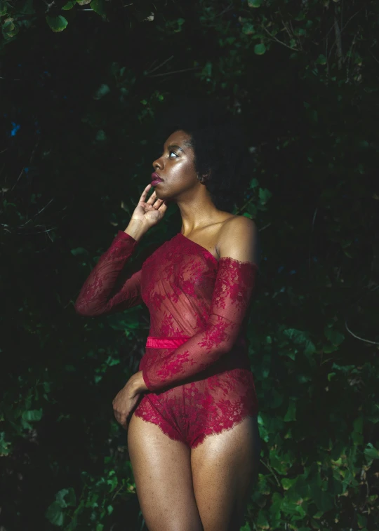 a woman in a red bodysuit talking on a cell phone, an album cover, inspired by Elsa Bleda, pexels, renaissance, black young woman, fine lace, outdoors at night, dressed in a frilly ((lace))