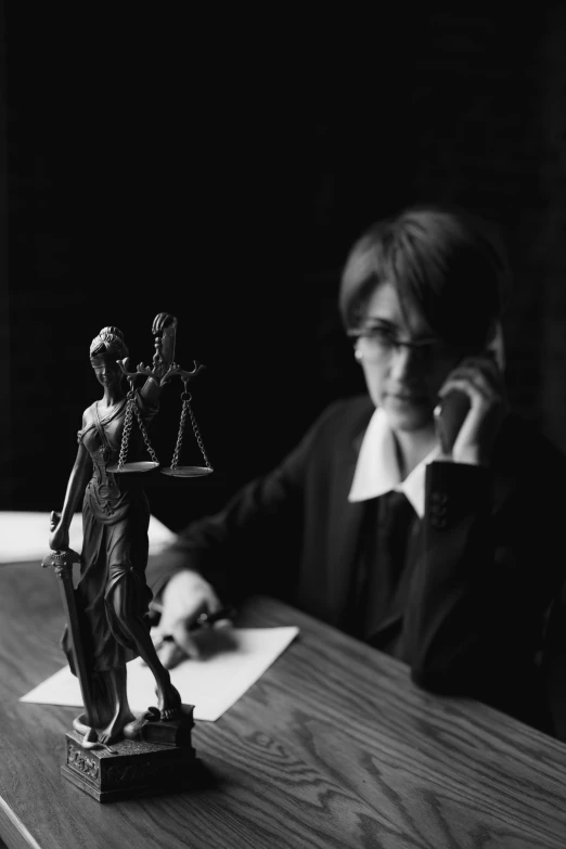 a woman sitting at a table talking on a cell phone, a statue, inspired by Kurt Wenner, unsplash, lawyer suit, collodion photograph, chiaroscuro!!, scales