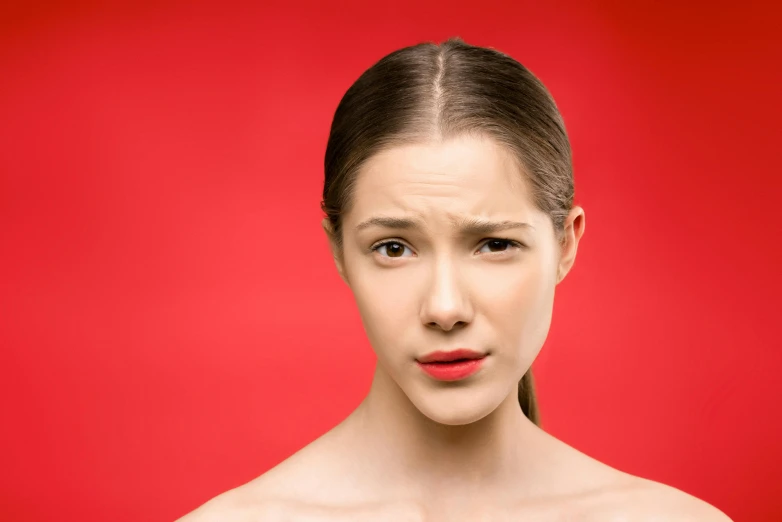 a woman with a surprised look on her face, an album cover, trending on pexels, antipodeans, in red background, dry skin, disappointed, slight stubble