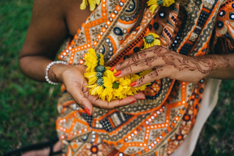 a woman holding a bunch of yellow flowers, trending on unsplash, hurufiyya, mehndi patterns, mixed art, floral clothes, sri lanka