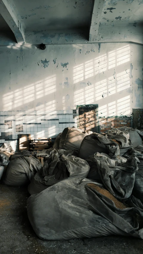 a room filled with lots of bags of trash, inspired by Elsa Bleda, unsplash contest winner, arte povera, soviet brutalism, harsh sunlight, photo taken on fujifilm superia, instagram photo